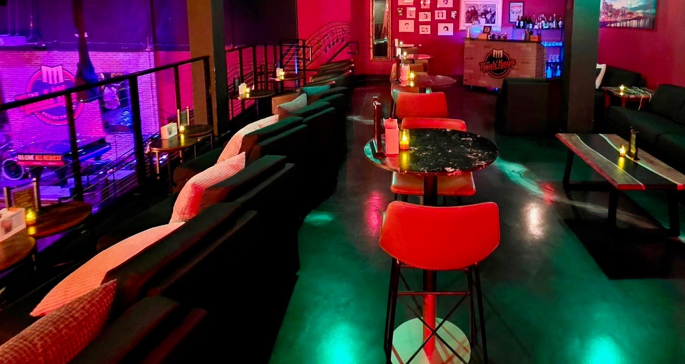 The VIP balcony at The Nash Keys &mdash; private bar, lounge seating and a second-floor view over the dueling piano stage
