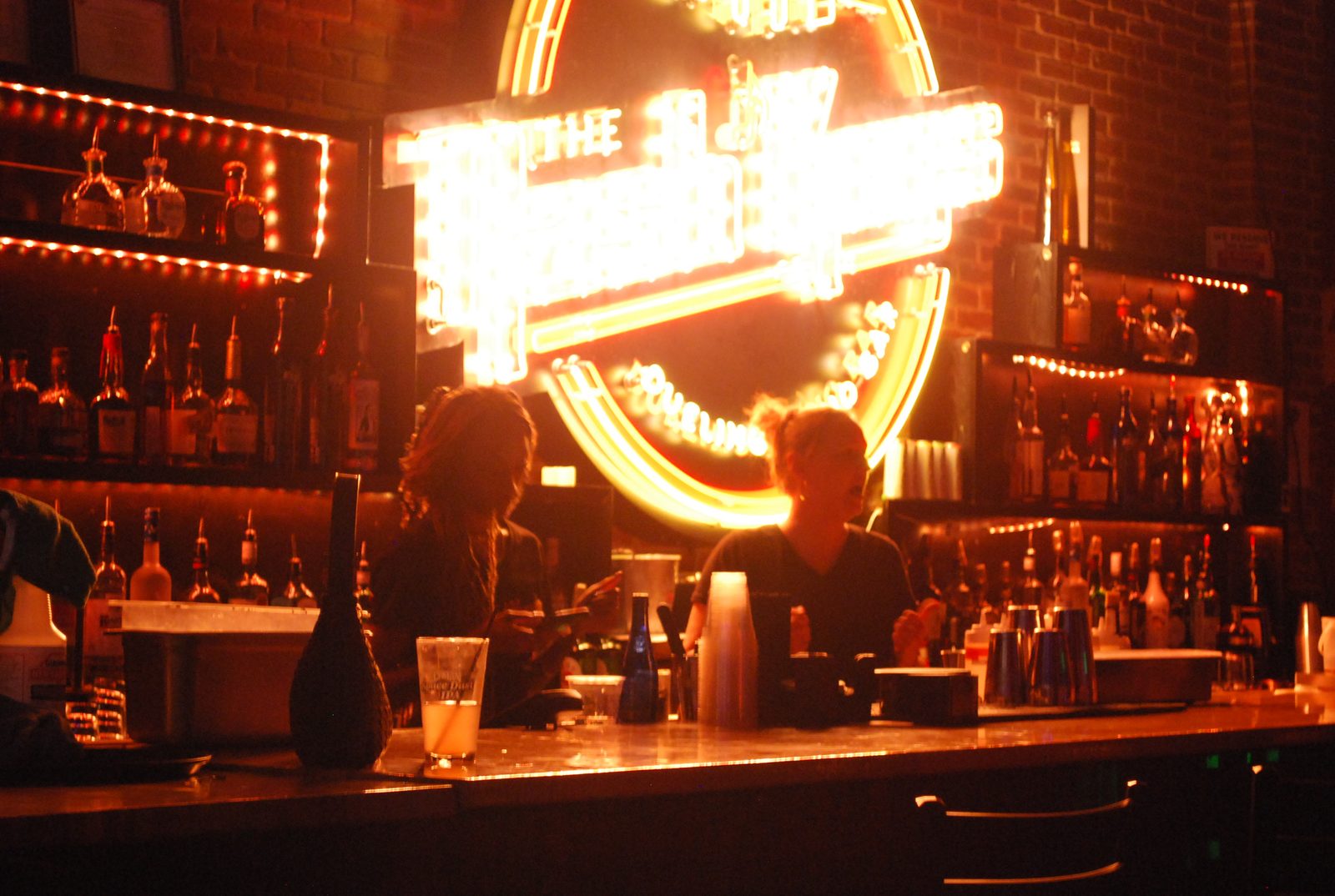 The Nash Keys bar at night — neon marquee glowing over the backbar in downtown Clearwater