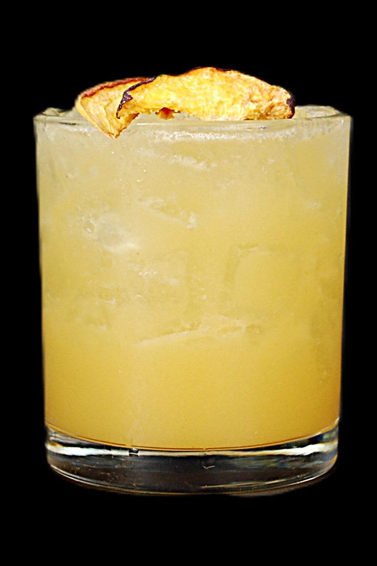 The Georgia Peach — golden Nash Keys cocktail on the rocks with a dried peach chip