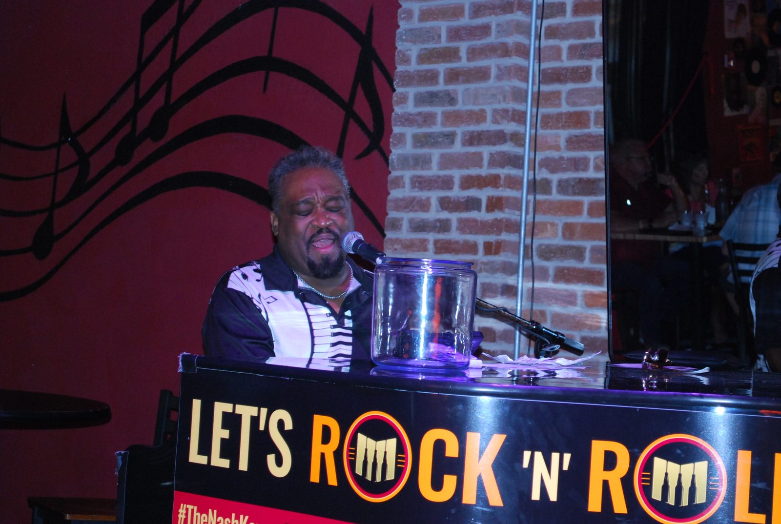 Pianist singing at the Let's Rock 'N' Roll piano at The Nash Keys